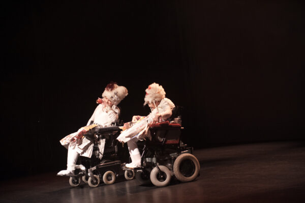 Two dancers in wheelchairs on a stage