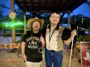 Mary Rose and Devin smile as they hold white canes